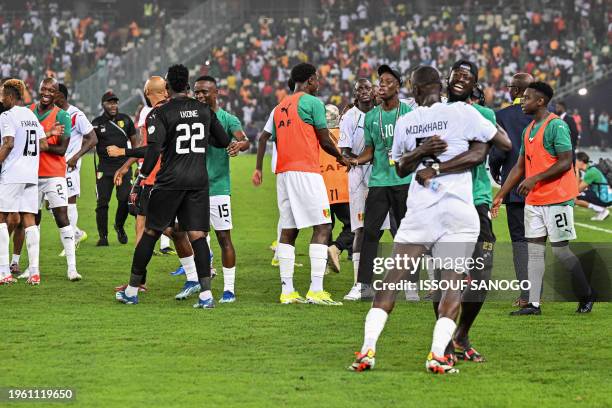 Guinea's players celebrate after the victory at the end of the Africa Cup of Nations 2024 round of 16 football match between Equatorial Guinea and...