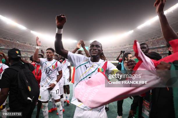 Guinea's defender Issiaga Sylla celebrates after the victory at the end of the Africa Cup of Nations 2024 round of 16 football match between...