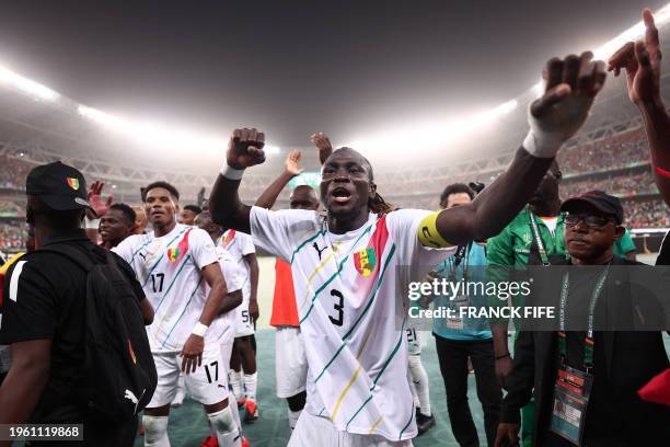 Guinea's defender Issiaga Sylla celebrates after the victory at the end of the Africa Cup of Nations 2024 round of 16 football match between...