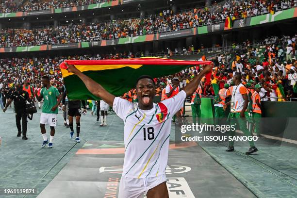 Guinea's midfielder Aguibou Camara celebrates after the victory at the end of the Africa Cup of Nations 2024 round of 16 football match between...