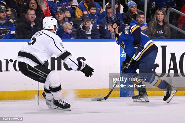 Matt Roy of the Los Angeles Kings defends against Jordan Kyrou of the St. Louis Blues on January 28, 2024 at the Enterprise Center in St. Louis,...