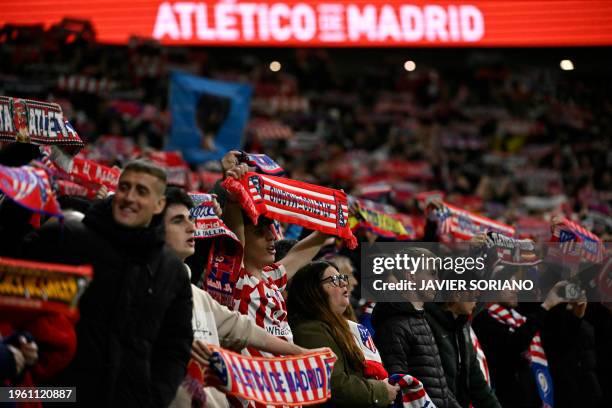 Atletico Madrid fans raise their scarves prior to the Spanish league football match between Club Atletico de Madrid and Valencia CF at the...