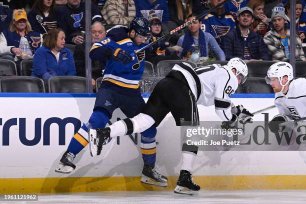 Marco Scandella of the St. Louis Blues checks Pierre-Luc Dubois of the Los Angeles Kings on January 28, 2024 at the Enterprise Center in St. Louis,...