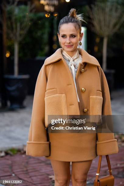 Pauline Chalamet wears brown jacket, skirt, bag outside Patou during the Haute Couture Spring/Summer 2024 as part of Paris Fashion Week on January...