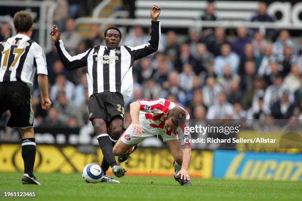 October 23: Shola Ameobi of Newcastle United and Alan Stubbs of Sunderland challenge during the Premier League match between Newcastle United and...