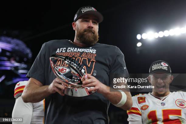 Travis Kelce of the Kansas City Chiefs holds the Lamar Hunt Trophy as Patrick Mahomes of the Kansas City Chiefs cheers after the AFC championship...