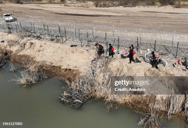 An aerial view of the area as migrants walking along razor wire after crossing the Rio Grande into the United States on January 28, 2024 in Eagle...