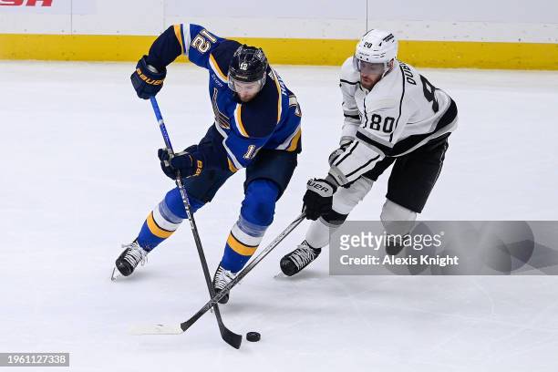 Kevin Hayes of the St. Louis Blues and Pierre-Luc Dubois of the Los Angeles Kings battle for the puck on January 28, 2024 at the Enterprise Center in...