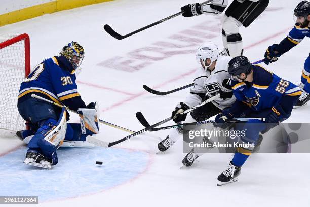 Joel Hofer and Colton Parayko of the St. Louis Blues defend the net against Matt Roy of the Los Angeles Kings on January 28, 2024 at the Enterprise...