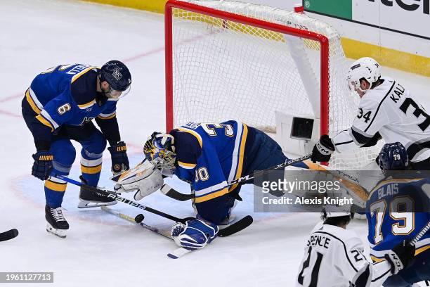 Joel Hofer and Marco Scandella of the St. Louis Blues defend the net against Arthur Kaliyev of the Los Angeles Kings on January 28, 2024 at the...