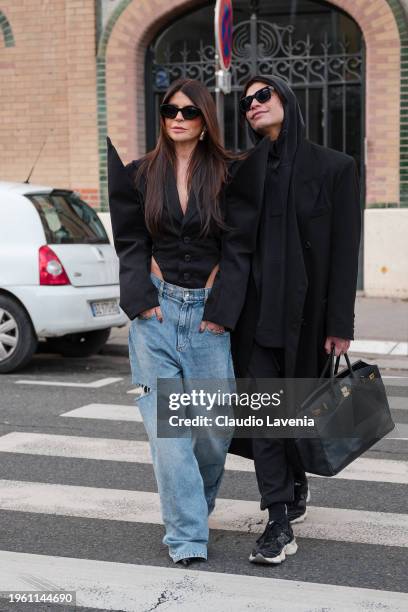 Olcay Gulsen wears black blazer with pointed sleeves, blue jeans, black sunglasses, outside Viktor & Rolf, during the Haute Couture Spring/Summer...