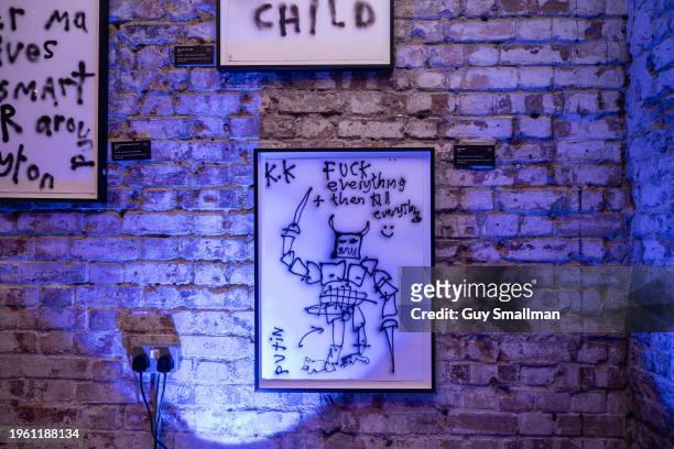 Individual pieces based on scrawled graffiti are displayed on January 25, 2024 in London, England. The show features installations and graphics...