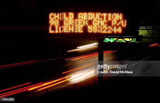 An Amber Alert freeway sign reads "CHILD ABDUCTION," giving a description of a vehicle suspected of being used in a Los Angeles kidnapping before...