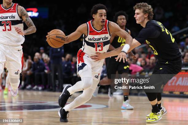 Jordan Poole of the Washington Wizards dribbles past Lauri Markkanen of the Utah Jazz during the first half at Capital One Arena on January 25, 2024...