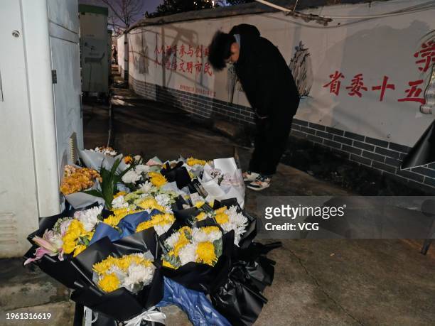 Man bows to mourn for victims near the site of a building fire on January 25, 2024 in Xinyu, Jiangxi Province of China. The fire happened at about 3...