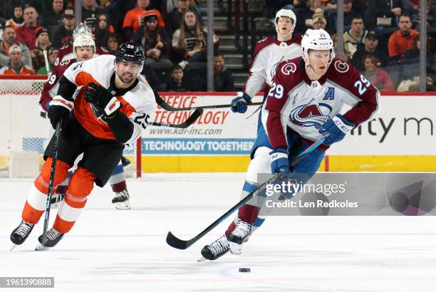 Nathan MacKinnon of the Colorado Avalanche skates the puck against Ryan Poehling of the Philadelphia Flyers at the Wells Fargo Center on January 20,...