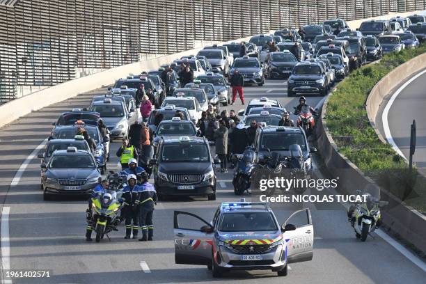 Taxis take part in a demonstration on the A50 highway as part of a national strike movement of the sector, to renegociate medical patients'...