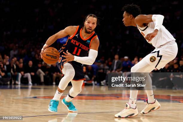 Jalen Brunson of the New York Knicks dribbles against Peyton Watson of the Denver Nuggets during the second half at Madison Square Garden on January...