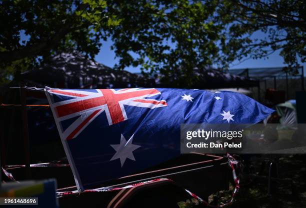 The Australian flag is attached to a trailer at a campground during Australia Day on January 26, 2024 in Tamworth, Australia. Australia Day, formerly...