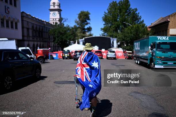 Man wears an Australian flag and a cork hat as he celebrates Australia Day on January 26, 2024 in Tamworth, Australia. Australia Day, formerly known...