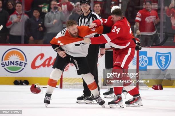 Klim Kostin of the Detroit Red Wings fights Nicolas Deslauriers of the Philadelphia Flyers during the second period at Little Caesars Arena on...