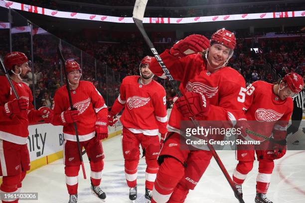 Moritz Seider of the Detroit Red Wings celebrates his second period goal with teammates while playing the Philadelphia Flyers at Little Caesars Arena...