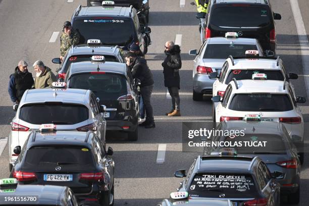 Taxis take part in a demonstration on the A50 highway as part of a national strike movement of the sector, to renegociate medical patients'...