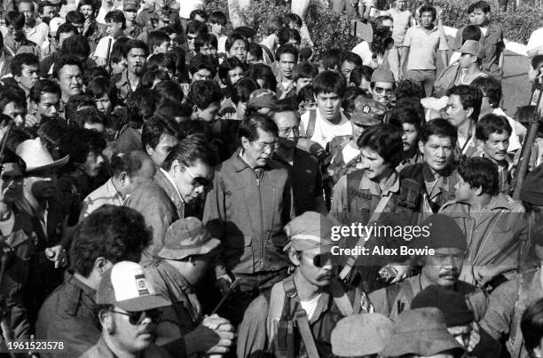 Defence Minister Juan Ponce Enrile and Vice Chief of Staff of the Armed Forces Lt. General Fidel Ramos are escorted by Colonel Gregorio Honansan and...