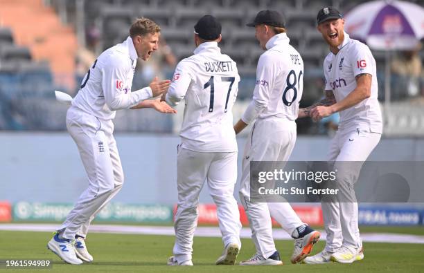 England bowler Joe Root celebrates with team mates after taking the wicket of Yashasvi Jaiswal during day two of the 1st Test Match between India and...