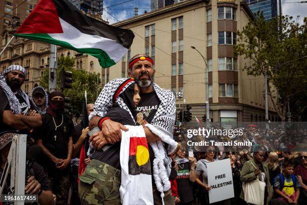 Palestinian father embraces his child in solidarity with Aboriginal people for the Invasion Day Rally on January 26, 2024 in Melbourne, Australia....