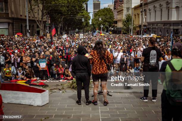 Mother and child stand on the stage in front of the crowd for the Invasion Day Rally on January 26, 2024 in Melbourne, Australia. Australia Day,...