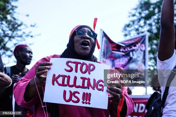 Protester marches while holding a placard during the demonstration. Protesters marched countrywide during the 'Feminists March Against Femicide,'...