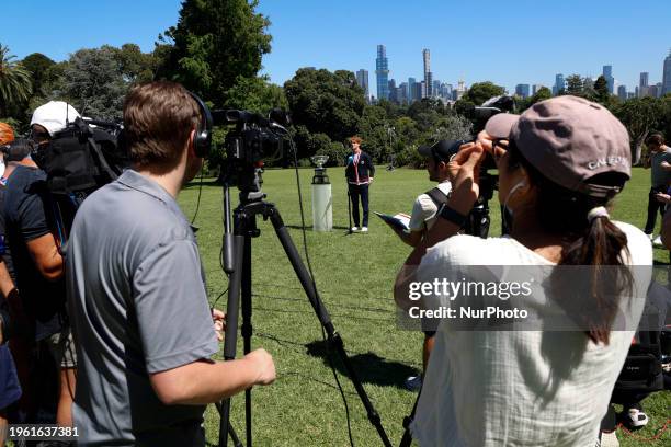 Jannik Sinner of Italy is speaking with the Norman Brookes Challenge Cup after winning the 2024 Australian Open Final at the Royal Botanic Gardens in...