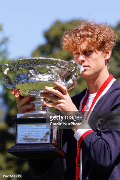 Jannik Sinner of Italy is posing with the Norman Brookes Challenge Cup after winning the 2024 Australian Open Final at the Royal Botanic Gardens in...