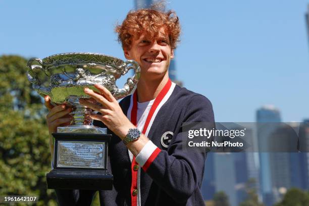 Jannik Sinner of Italy is posing with the Norman Brookes Challenge Cup after winning the 2024 Australian Open Final at the Royal Botanic Gardens in...