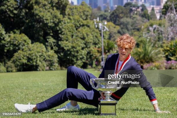 Jannik Sinner of Italy is posing with the Norman Brookes Challenge Cup after winning the 2024 Australian Open Final at the Royal Botanic Gardens in...