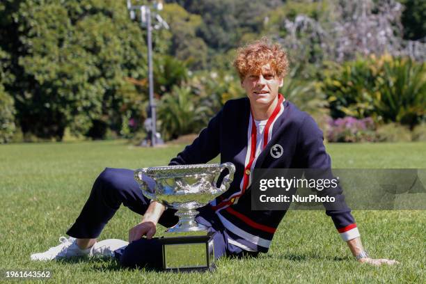 Jannik Sinner of Italy is posing with the Norman Brookes Challenge Cup after winning the 2024 Australian Open Final at the Royal Botanic Gardens in...