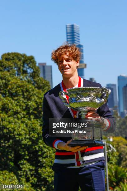 Jannik Sinner of Italy is posing with the Norman Brookes Challenge Cup after winning the 2024 Australian Open Final at the Royal Botanic Gardens in...