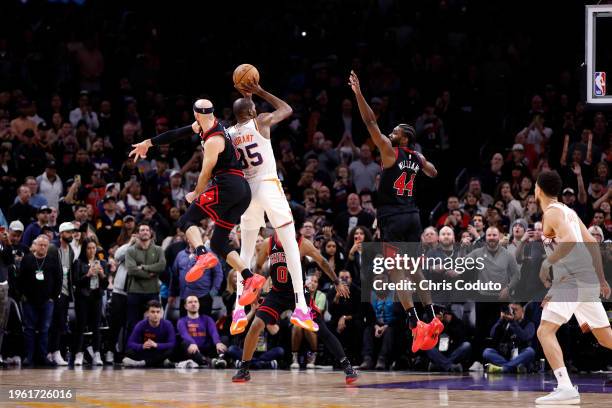 Kevin Durant of the Phoenix Suns hits the go ahead three pointer over Alex Caruso of the Chicago Bulls and Patrick Williams during the game at...