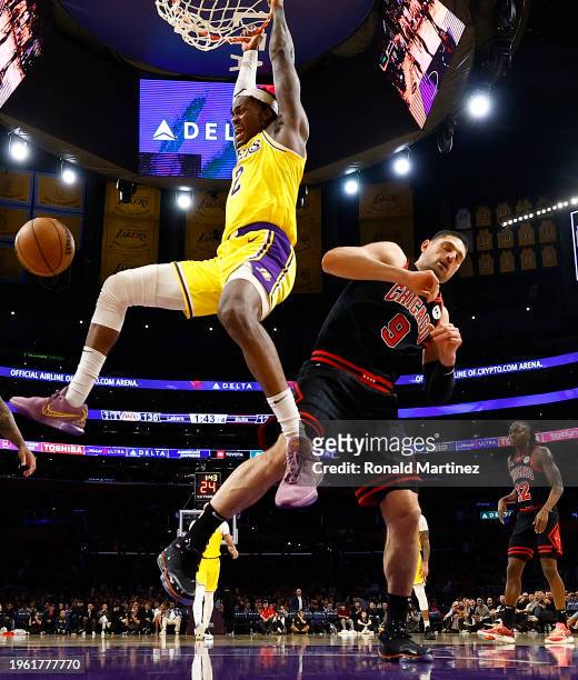 Jarred Vanderbilt of the Los Angeles Lakers makes a slam dunk against Nikola Vucevic of the Chicago Bulls in the second half at Crypto.com Arena on...