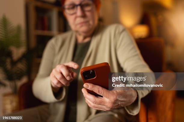 senior lady with smartphone - fraud prevention stock pictures, royalty-free photos & images