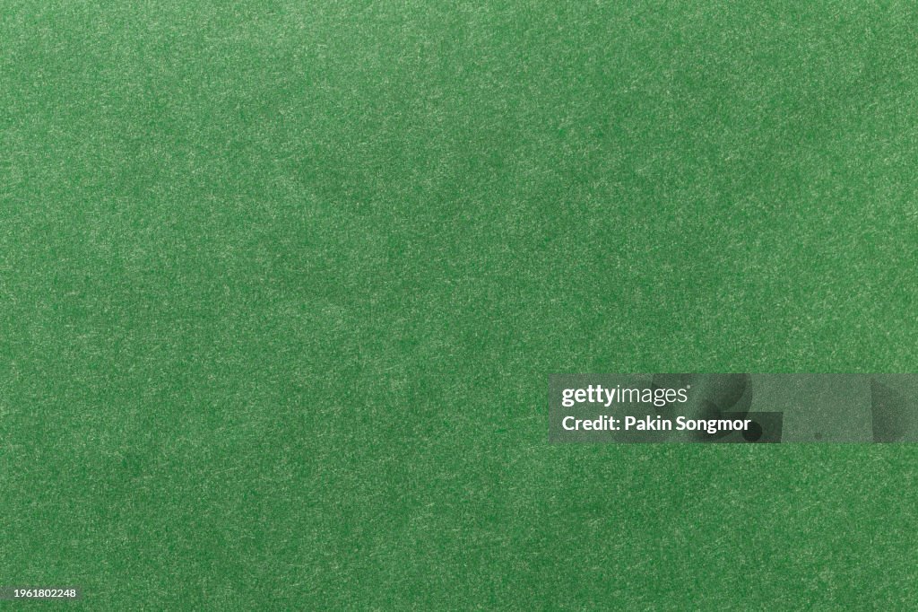 Green color paper sheet texture cardboard background.