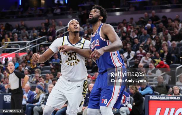 Myles Turner of the Indiana Pacers and Joel Embiid the Philadelphia 76ers battle for position during the second half of the game at Gainbridge...