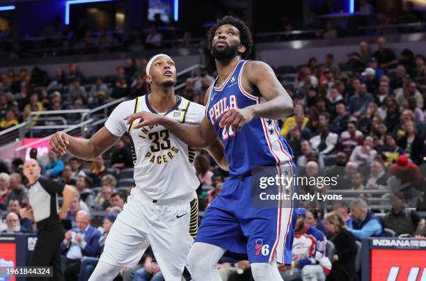 Myles Turner of the Indiana Pacers and Joel Embiid the Philadelphia 76ers battle for position during the second half of the game at Gainbridge...