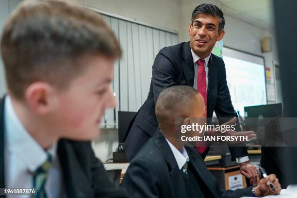 Britain's Prime Minister Rishi Sunak meets with students taking part in a personal development lesson as he visits Haughton Academy in Darlington,...