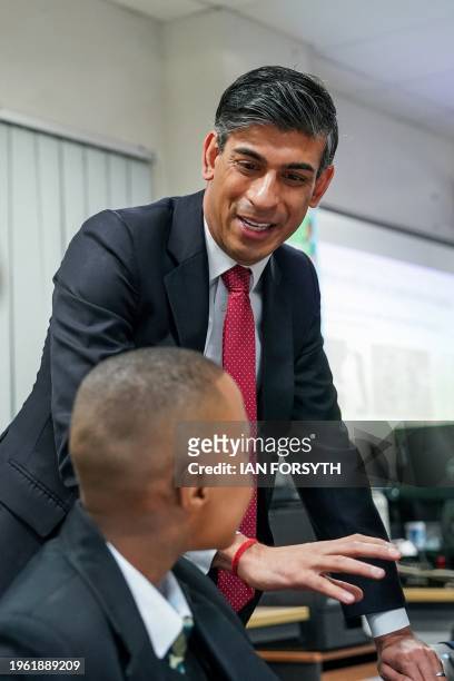 Britain's Prime Minister Rishi Sunak meets with students taking part in a personal development lesson as he visits Haughton Academy in Darlington,...