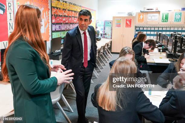 Britain's Prime Minister Rishi Sunak meets with students taking part in a personal development lesson as he visits Haughton Academy in Darlington,...