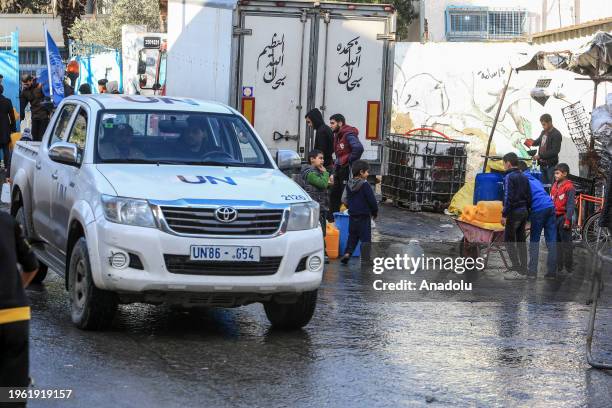 Palestinians collect drinkable water provided by the mobile tankers of UN amid acute shortages of food, clean water and medicine due to Israeli...