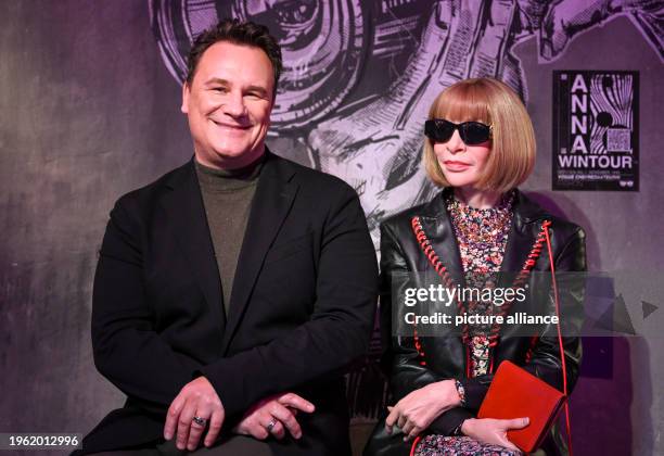 January 2024, Berlin: Fashion designer Guido Maria Kretschmer sits next to the wax figure of Anna Wintour at her presentation at Madame Tussauds....