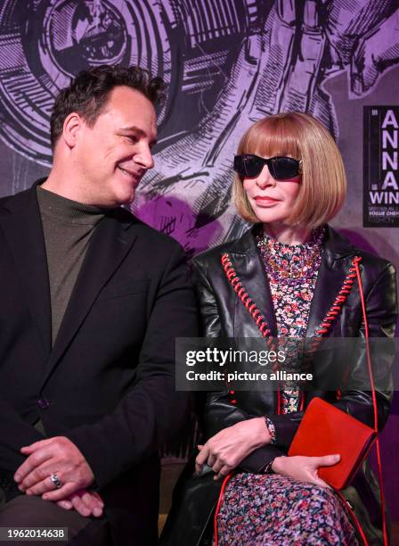 January 2024, Berlin: Fashion designer Guido Maria Kretschmer sits next to the wax figure of Anna Wintour at her presentation at Madame Tussauds....